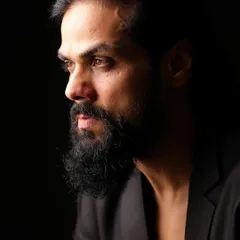 A striking profile shot of actor Arpit Ranka. The dramatic lighting and sharp focus create a powerful and intense character portrait, perfect for showcasing his commanding presence on screen.