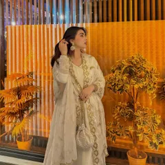 An elegant white and gold embroidered Anarkali suit, perfect for a wedding guest or special event.