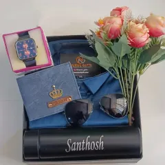 This stylish blue-themed hamper features a shirt, a personalized denim wallet, a watch, sunglasses, and a name-engraved flask, along with a lovely bouquet of flowers.