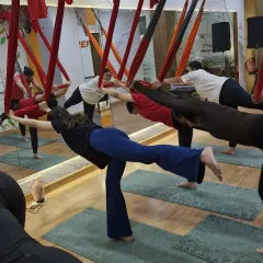 This suspended warrior-like pose is a perfect example of how we build strength and stability. It requires core engagement, leg strength, and focus, all while using the hammock for balance and support.