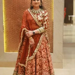 A full-length portrait of my client, looking elegant in a floral lehenga. The makeup is soft and sophisticated, perfect for a wedding guest.