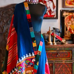 A close-up detail of the chadar's patchwork border, where you can see the different textures of Kutchi embroidery, Balinese cotton, and Laotian hemp coming together.