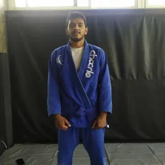 Standing proud in my new blue belt and Gi. This represents a new chapter in my Jiu-Jitsu journey, with much more to learn.