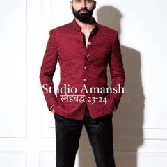 Our crimson bandhgala is crafted to make you stand out. This frontal view highlights the jacket's impeccable fit and the quality of its unique, self-embroidered fabric, perfect for making a lasting impression.