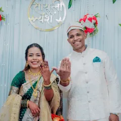 The moment it becomes official. The happy couple proudly shows off their new engagement rings, dressed in beautiful Maharashtrian attire under a custom sign with their names, "Sayali" and "Yash".