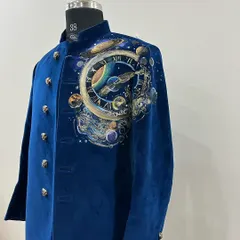 This piece is a universe painted on velvet. For this custom sherwani, I captured the magic of the cosmos, with swirling galaxies and planets around a celestial clock, creating a truly one of a kind garment for a client who wanted to wear the stars.