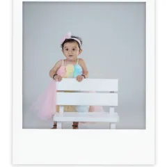 A beautiful portrait in a polaroid-style frame. This little girl looks so sweet and elegant in her pastel dress.