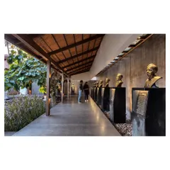 The Rishi Pavilion at the KLE Museum serves as the primary entry path. The landscape becomes performative, guiding visitors along a curated journey past the busts of the institution's founders.
