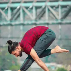 A student holds a variation of Parsvottanasana (Pyramid Pose), a deep stretch for the hamstrings and spine. This advanced posture requires both flexibility and balance, two key areas we focus on in my training.