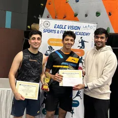 Our coaches celebrating a men's doubles win at the Corporate Sports Connect Tournament. Their success serves as a direct inspiration for our students.