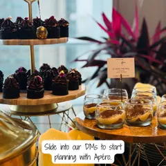 A close-up of a dessert station from one of our catered events. We feature treats like individual classic Tiramisu cups and mini Belgian dark chocolate ganache cakes, ensuring there's a sweet bite for everyone.