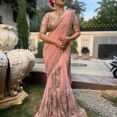 Another angle of the client in her pink saree, showcasing the perfect pleats and fall of the fabric. My draping service ensures you look flawless from every angle.
