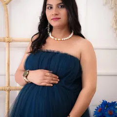 A lovely close-up portrait of an expecting mother. Her serene expression and the soft details of her pearl necklace create a classic and timeless maternity photo.