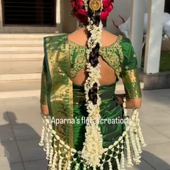 This unique Thai-patterned floral 'shela' is a statement piece for any bride. The intricate netting is woven entirely from fresh flower buds, creating a delicate and elegant drape.