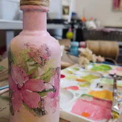 A close-up view of the decoupage bottle, where you can see the subtle textures and the rustic jute twine I used to wrap the cap. It's these little handmade details that make each piece special.