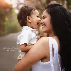 A beautiful, candid moment of a mother and her son sharing a laugh outdoors, their noses touching. This is the kind of pure, unposed joy I love to capture in my family photography sessions.