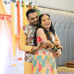 A candid moment of pure joy during the Sangeet. The groom embraces his bride from behind as they share a heartfelt laugh.