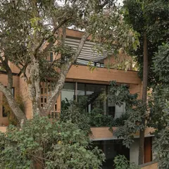 The stepping volumes, terraces, and integrated gardens of the Debris Block House in Bangalore. The design creates multiple connections to the lush, tropical landscape that surrounds the home.