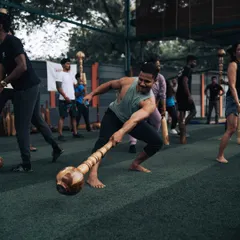 An attendee of our L1 Certification program masters a dynamic lunge with the Gada. Our hands-on approach ensures every participant learns the correct form and technique.