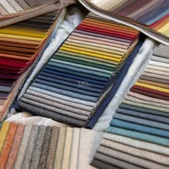 Dive into a world of textures and hues with our upholstery fabric collection. This image showcases a rainbow of options, from rich velvets to rustic weaves, each offering a unique personality for your custom furniture.