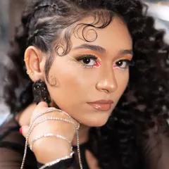 For this creative shoot, I designed a multi-colored nail set to match the model's vibrant makeup. Each nail is a different color, creating a playful yet edgy look that stands out.