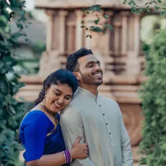 Love and laughter in traditional wear. This candid moment captures the pure joy and comfort the couple shares, proving that traditional shoots can be full of fun.