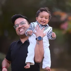 A different angle from the same playful moment, this time focusing on the joyful expressions of both father and son. Capturing multiple shots ensures we get the perfect image.