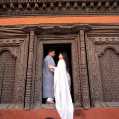 A pre-wedding portrait set against intricately carved wooden doors in Varanasi. The rich textures and history of the location add a layer of depth to their love story.