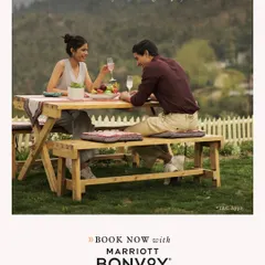 A couple enjoys a private picnic on the lawn, a perfect way to discover more happy places and enjoy exclusive member benefits with Marriott Bonvoy.
