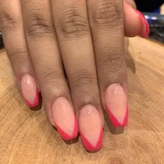 A bold and modern V-shaped French tip. Using a bright pink instead of the traditional white gives this classic look a fun and contemporary twist.