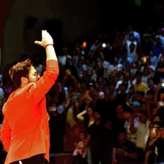 Waving to a massive audience in Patna. Connecting with every section of a large auditorium is a skill I've honed over years of hosting big events.