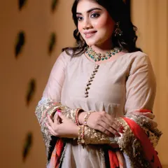 The model poses in a beautiful beige outfit by Esha Bhatia, showcasing the full look with jewelry from Ketan Kumar Sagar, perfect for a designer campaign.