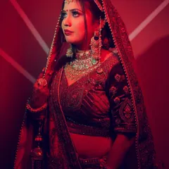 A bridal portrait using a strong red light and a patterned background to create a bold and modern look.