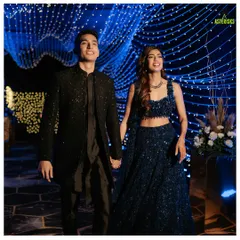 The couple makes a grand entrance, walking hand-in-hand under a canopy of twinkling fairy lights, setting a magical tone for their Sangeet night.
