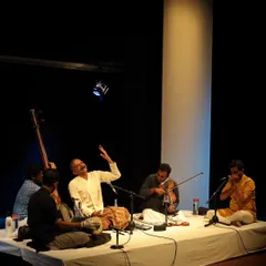 A wide shot of T.M. Krishna and his ensemble on our stage, creating an intimate and immersive musical experience for the audience.