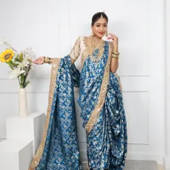 This royal blue brocade Nauvari with a golden border is a statement piece, ideal for weddings and grand receptions.