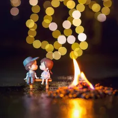A miniature couple sits by a tiny bonfire, with the warm glow of the flame and background lights creating a cozy and intimate atmosphere.