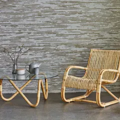 Here is a classic rattan lounge chair paired with a matching coffee table that has a durable glass top. This design highlights the gentle curves and expert binding I use to create comfortable and timeless pieces for any living space.