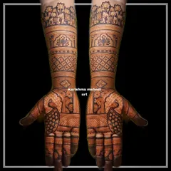 A symmetrical bridal design featuring peacocks on the palms and a procession of elephants at the top of the arms. The use of negative space makes the traditional motifs stand out beautifully.