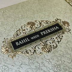 A beautiful embossed card with a floral brocade pattern. The gold-on-cream design is a classic choice for timeless elegance.