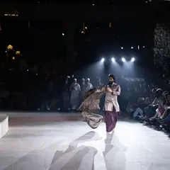 Ranveer Singh in motion on the runway, his sherwani flowing. This action shot showcases the garment's design and the actor's dynamic energy.