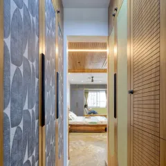 The walk-through wardrobe space in the Villa 17 master bedroom. We used different textures and patterns on the teak-framed shutters to add visual interest.