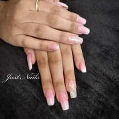 A pretty pink and white ombre set on long, square-shaped nails, with a beautiful encapsulated glitter accent nail.