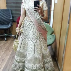 A mirror selfie from a client on her big day. She paired her embroidered lehenga with a rental Kundan choker and matching bangles, showing a personal and happy moment while getting ready.