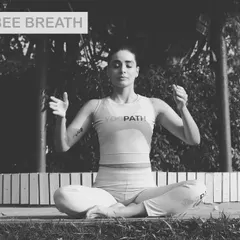A practitioner demonstrates Bhramari Pranayama, also known as the Humming Bee Breath. This technique is incredibly effective for instantly calming the mind, relieving tension, and reducing feelings of anxiety.