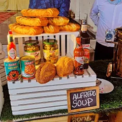 Our Alfredo Soup station setup, showcasing the ingredients and breads that accompany this creamy, classic Italian soup.