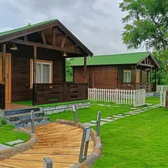 A look at a finished resort-style farmhouse project. I designed the entire space, including the healthy green lawn, the custom wooden walkway, and the stone-paved path, to create a peaceful and high-end retreat.