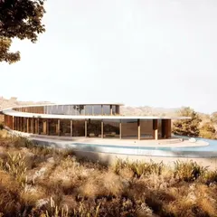 The exterior of Amar Villa, showing how the structure integrates with the arid landscape of Udaipur. The design uses locally sourced stone and lime plaster to echo the colors of the surroundings.