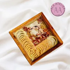 A beautiful preservation of a bride's chuda. The light-colored bangles are arranged artfully next to the couple's wedding photo and preserved flowers, all encased in a classic teakwood frame.