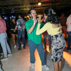 Fun and laughter are guaranteed at our Friday Night Open Floor. Here, two dancers share a playful moment while practicing their moves in a relaxed, social setting.